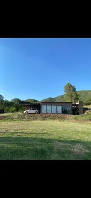 a car is parked in front of a house at Jardines de estrellas in Santa Rosa de Calamuchita