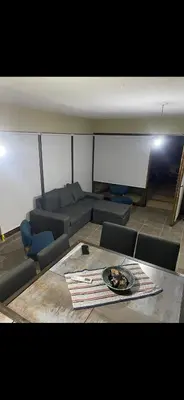 a living room with couches and a table with a plate on it at Jardines de estrellas in Santa Rosa de Calamuchita