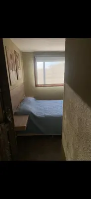 a small bedroom with a bed and a window at Jardines de estrellas in Santa Rosa de Calamuchita