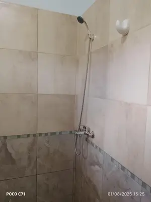 a shower with a shower head in a bathroom at Tacuarita in Los Hornillos