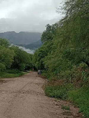 a car parked on the side of a dirt road at Tacuarita in Los Hornillos