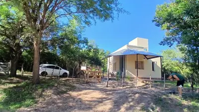 a man standing in front of a building at Tacuarita in Los Hornillos