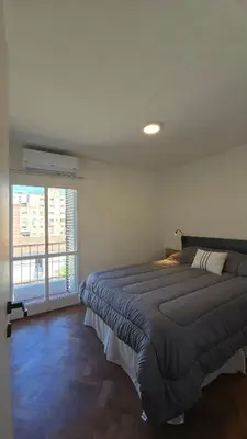 a bedroom with a bed and a large window at ALV26 4G -Departamento Sobremonte in Cordoba