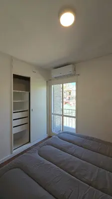 a large bed in a room with a large window at ALV26 4G -Departamento Sobremonte in Cordoba