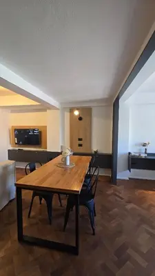 a dining room with a wooden table and chairs at ALV26 4G -Departamento Sobremonte in Cordoba