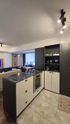 a kitchen with white cabinets and a stove top oven at ALV26 4G -Departamento Sobremonte in Cordoba