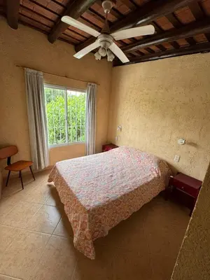 a bedroom with a bed and a large window at Sol y Río in Villa Carlos Paz