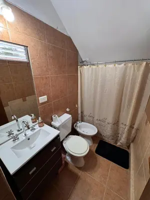 a bathroom with a sink and a toilet and a shower at Sol y Río in Villa Carlos Paz