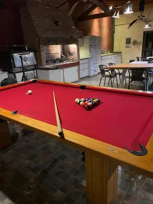 a red pool table with a ball on it at Casa de Categoria, Villa Del Lago, Cap 8 pers in Villa Carlos Paz