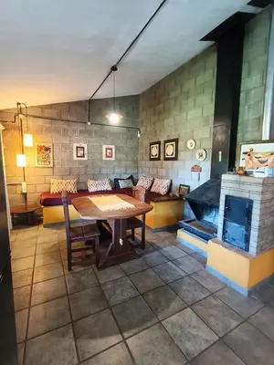 a living room with a table and a fireplace at El Algarrobo Casa de campo en Cabalango in Cavalango