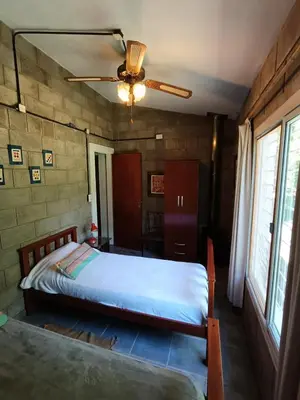 a bedroom with a bed and a ceiling fan at El Algarrobo Casa de campo en Cabalango in Cavalango