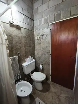 a small bathroom with a toilet and a sink at El Algarrobo Casa de campo en Cabalango in Cavalango