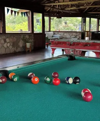 a pool table with a group of balls on at Cabaña Los Nogales- Naturaleza y relax en Altas Cumbres in Arroyo de Los Patos