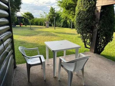 a table and two chairs and a white table and chairs at Cabañas El Atalaya in Villa Rumipal