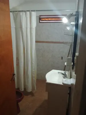 a bathroom with a shower curtain and a sink at casa para 12 personas en bialet in San Roque