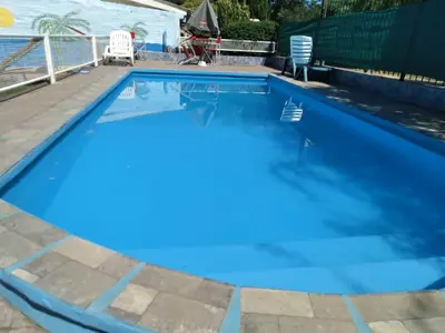a swimming pool with blue water in a backyard at casa para 12 personas en bialet in San Roque