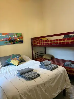 a bedroom with a bed with two towels on it at Casa de campo Marines in San Antonio de Arredondo