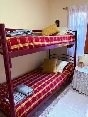 two bunk beds in a room with a bed on top at Casa de campo Marines in San Antonio de Arredondo