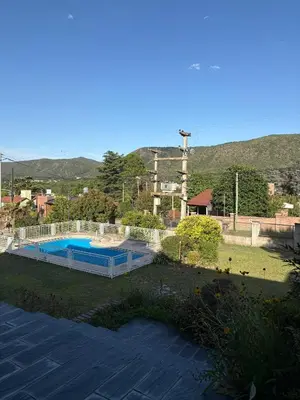a swimming pool in a yard with mountains in the background at Casa de campo Marines in San Antonio de Arredondo