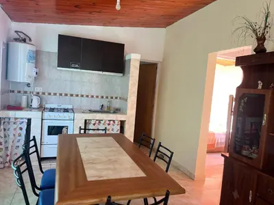 a kitchen and dining room with a wooden table at Timtaya in Barrio Parque El Corcovado