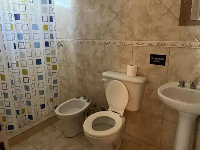 a bathroom with a toilet and a sink at Timtaya in Barrio Parque El Corcovado