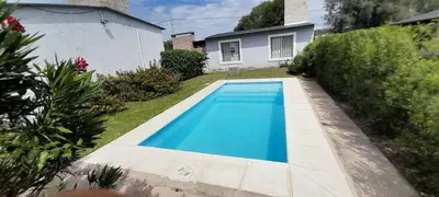 a blue swimming pool in the yard of a house at Timtaya in Barrio Parque El Corcovado