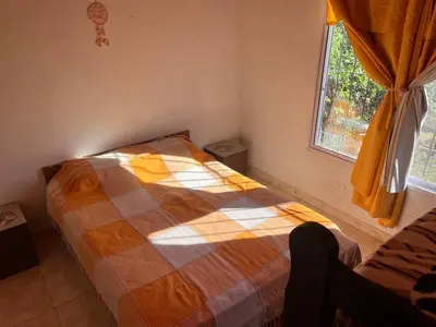 a bedroom with a bed and a window at Timtaya in Barrio Parque El Corcovado