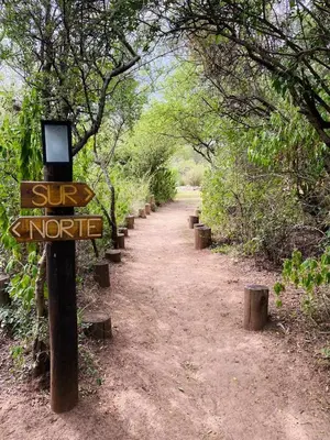a dirt trail with a sun notice sign on it at Glamping Traslasierra Carpa Sur in San Javier