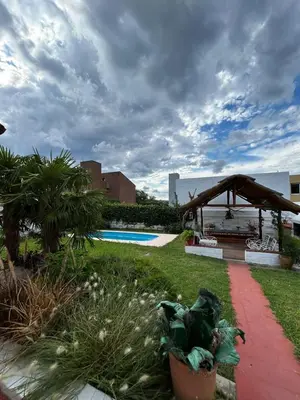 a garden with a pavilion and a swimming pool at Casa Jaz in Villa Carlos Paz