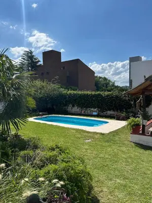 a swimming pool in the yard of a house at Casa Jaz in Villa Carlos Paz