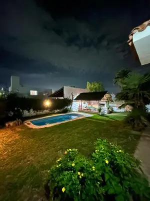 a yard with a swimming pool at night at Casa Jaz in Villa Carlos Paz