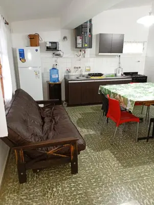 a kitchen with a couch and a table in a kitchen at Hermosa Casa equipada a metros del Río Cosquín in Bialet Massé