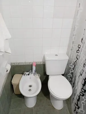 a bathroom with a toilet and a sink at Hermosa Casa equipada a metros del Río Cosquín in Bialet Massé