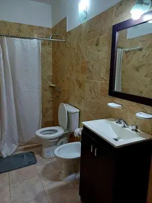 a bathroom with a toilet and a sink and a mirror at Colibrí Del Lago in Villa Parque Siquiman