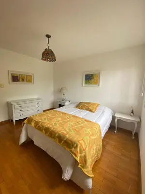 a bedroom with a bed and a table and a lamp at Departamento Nuñez in Cordoba