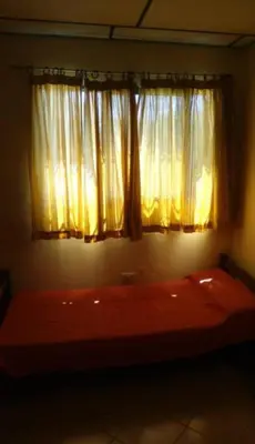 a bed in a room with a window at Departamento Cerca de Todo in Villa de Las Rosas