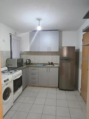 a kitchen with a refrigerator and a sink in it at Hermoso Dpto Nva Cordoba in Cordoba