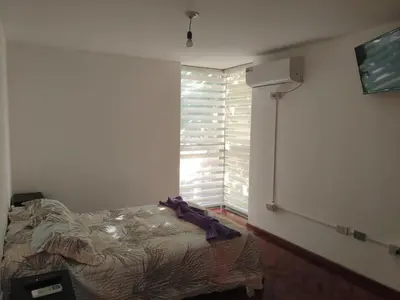 a bedroom with a bed and a window with blinds at Hermoso Dpto Nva Cordoba in Cordoba