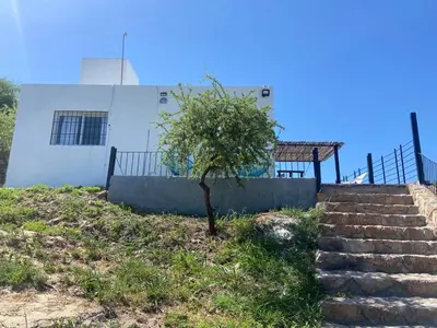 a tree in front of a building with stairs at Loft serenity in Villa Carlos Paz
