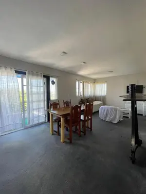 a dining room with a table and chairs and a bedroom at Loft serenity in Villa Carlos Paz
