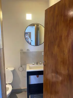 a person taking a picture of a bathroom with a mirror at Loft serenity in Villa Carlos Paz