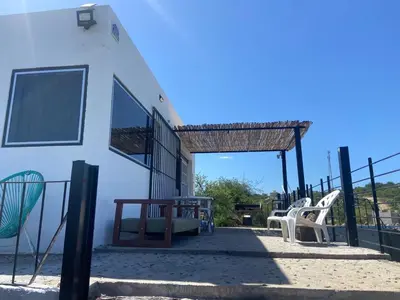 a group of chairs sitting on the side of a building at Loft serenity in Villa Carlos Paz