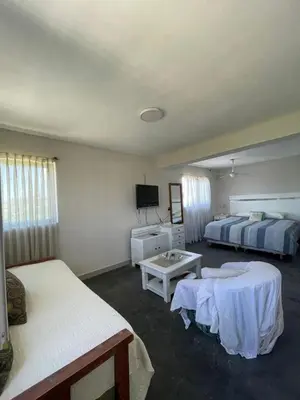 a hotel room with two beds and a tv at Loft serenity in Villa Carlos Paz
