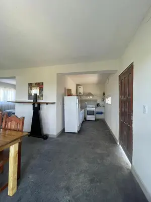 a kitchen with a white refrigerator and a stove at Loft serenity in Villa Carlos Paz