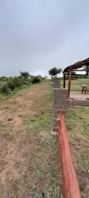 a red pipe in a field next to a building at El arroyense in Cordoba