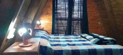 a bedroom with a blue and white bed and a lamp at El arroyense in Cordoba
