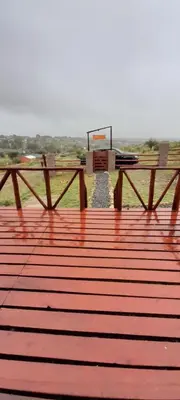 a picnic table and bench on a wooden deck at El arroyense in Cordoba