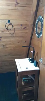 a bathroom with a table and a mirror on a wall at El arroyense in Cordoba