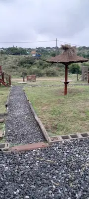 a gravel path with an umbrella on a field at El arroyense in Cordoba