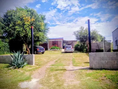 a house with two cars parked in a yard at Casitas Serranas en Santa María de Punilla in Santa María